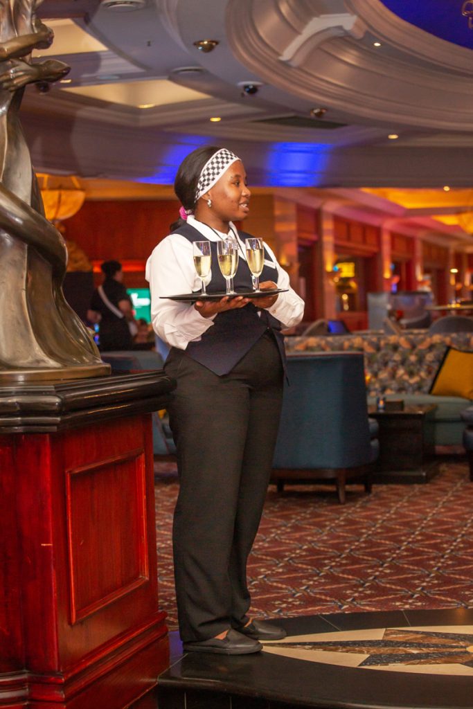 Female waiter with a tray of drinks in her hands